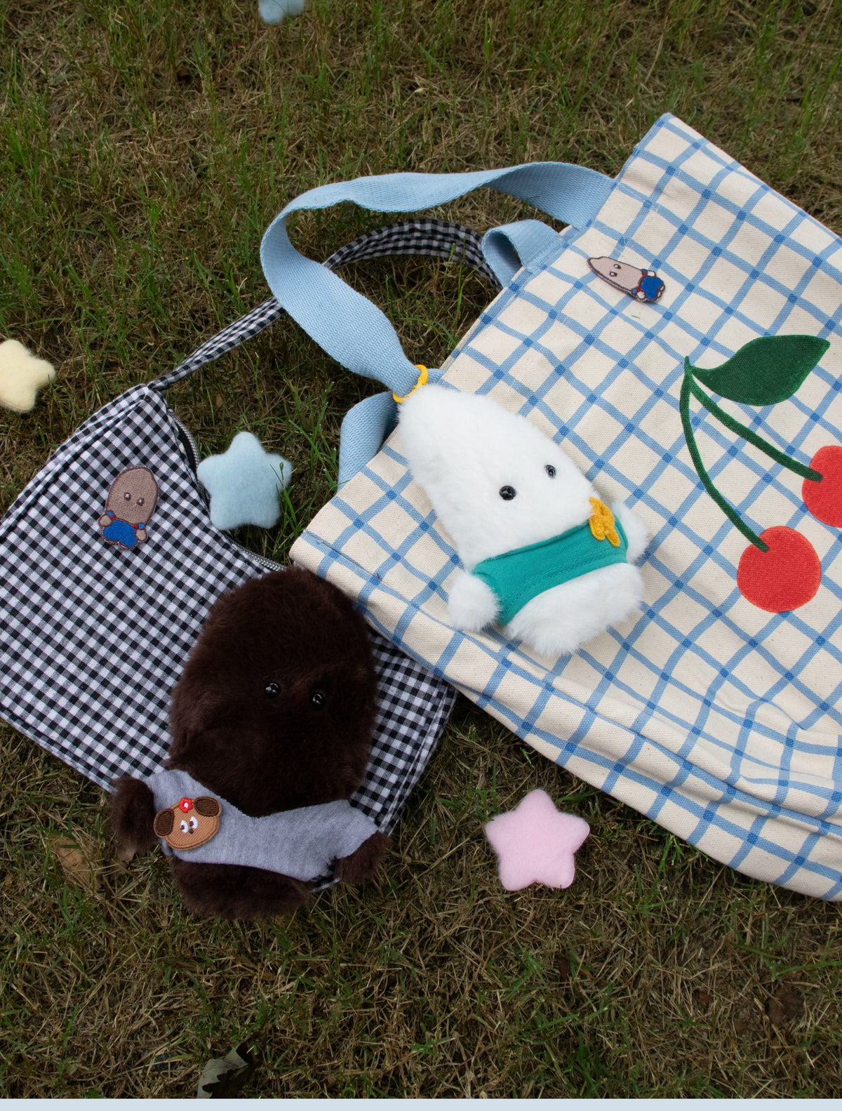 Tote bag with plush keychains on grass